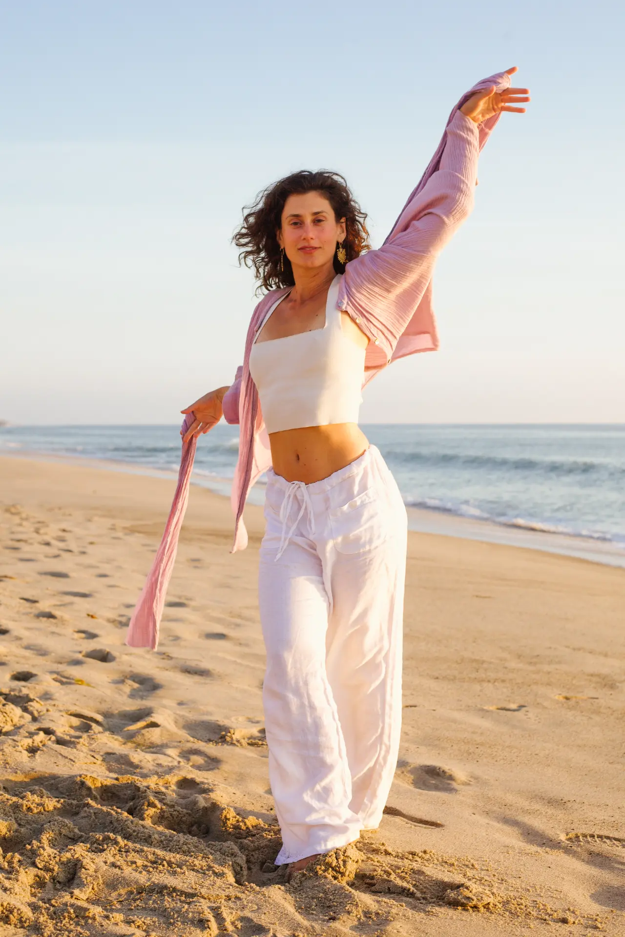 Nadia Sessen on the beach at golden hour